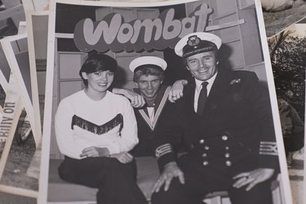 Black and white publicity image showing two men in sailor caps and a woman. Show 'Wombat' signage
