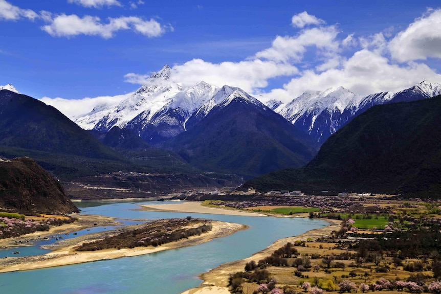 The Yarlung Tsangpo river flows at the foothills of a giant Himalayan mountain range