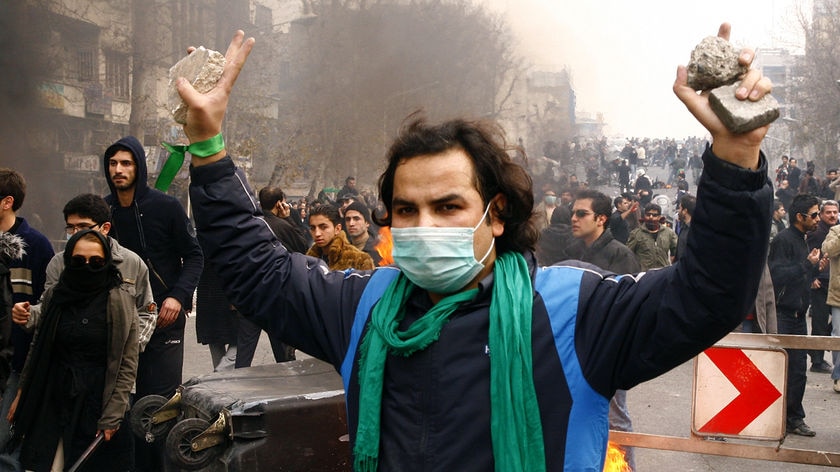 An Iranian opposition supporter gestures during clashes with security forces in Tehran.