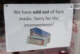 A sign saying face masks have sold out at a pharmacy