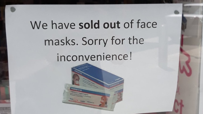 A sign saying face masks have sold out at a pharmacy
