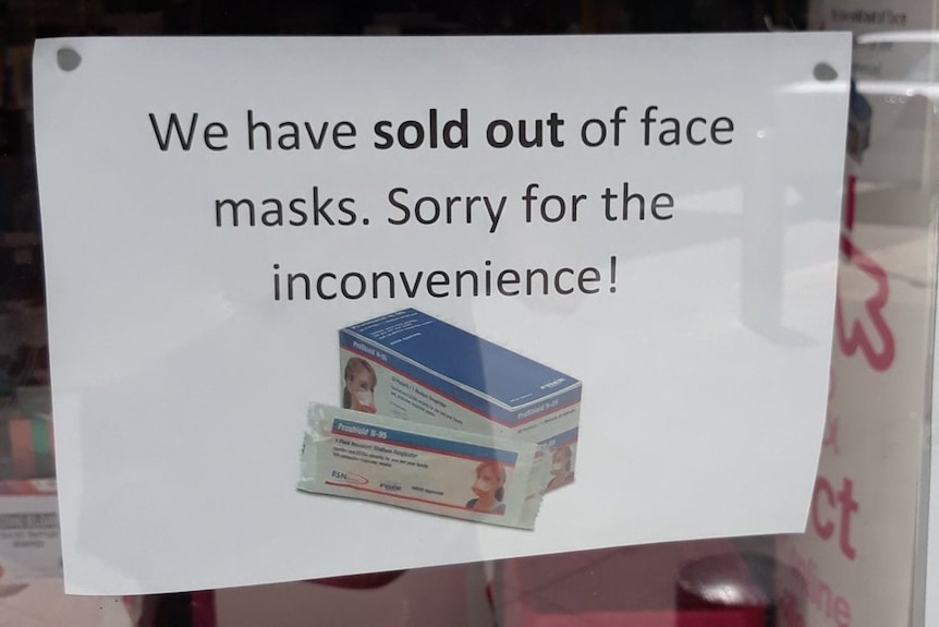 A sign saying face masks have sold out at a pharmacy