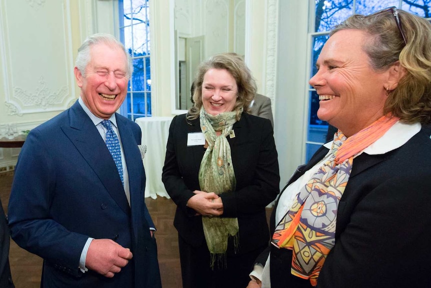 Louise Hardman in the foreground of a meeting with a laughing Prince Charles and others, in London, in 2018.