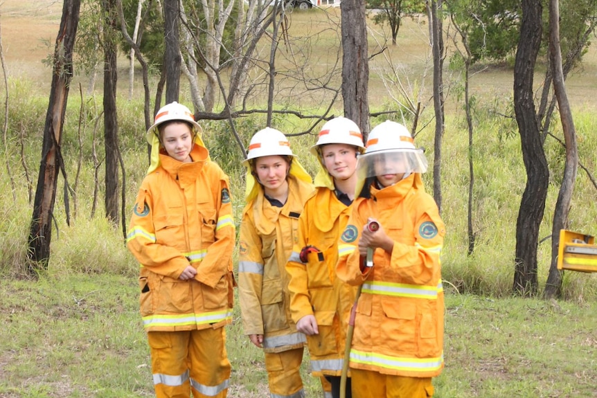 young firefighters holding hose
