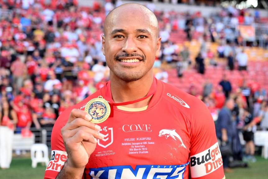 Felise Kaufusi shows off the Artie Legacy Medal after the Dolphins beat the Sydney Roosters.
