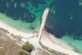 A satellite photo of a rocky jetty.