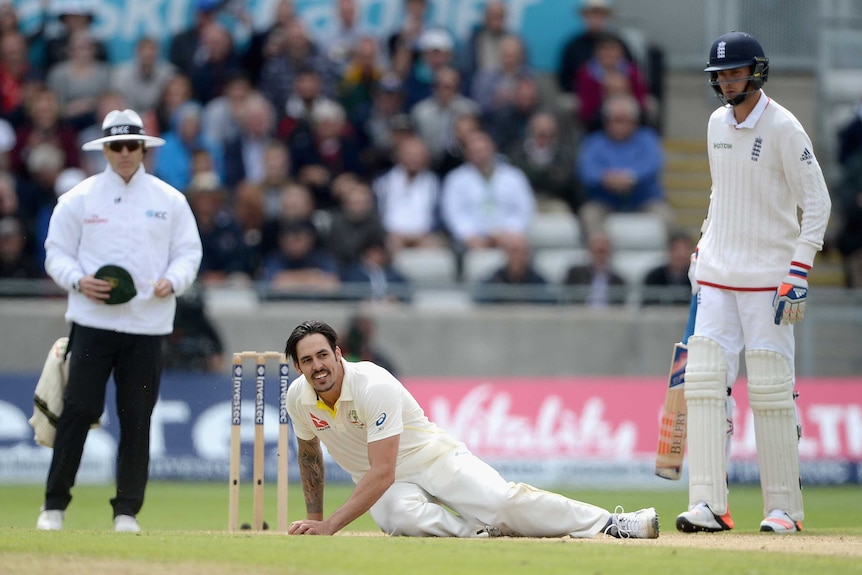 Mitchell Johnson falls over after bowling on day two at Edgbaston.