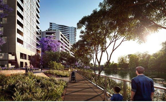 Riverwalk with trees and people with families walking along