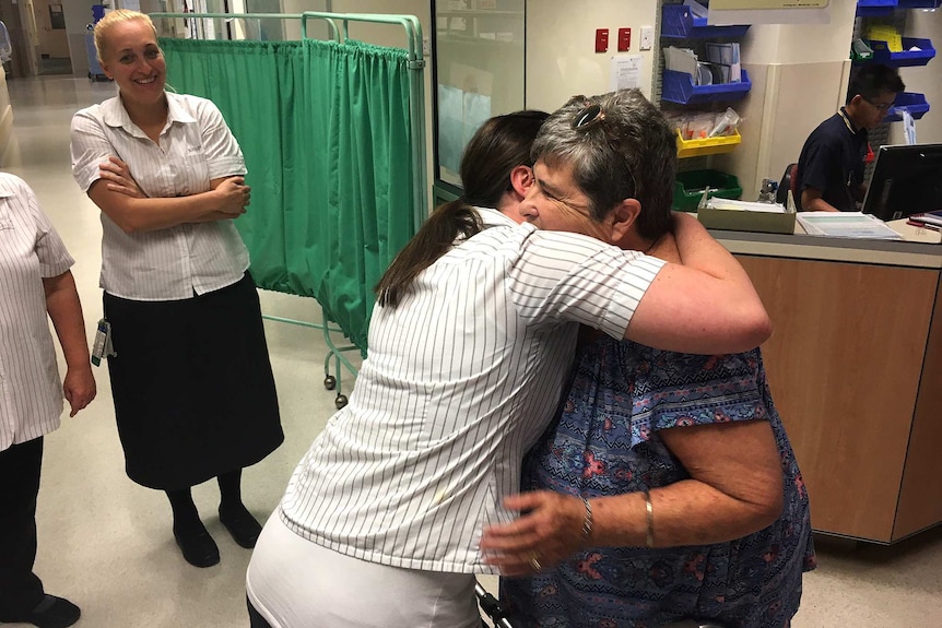 Mandy Illman is hugged by a nurse after returning to hospital on her feet