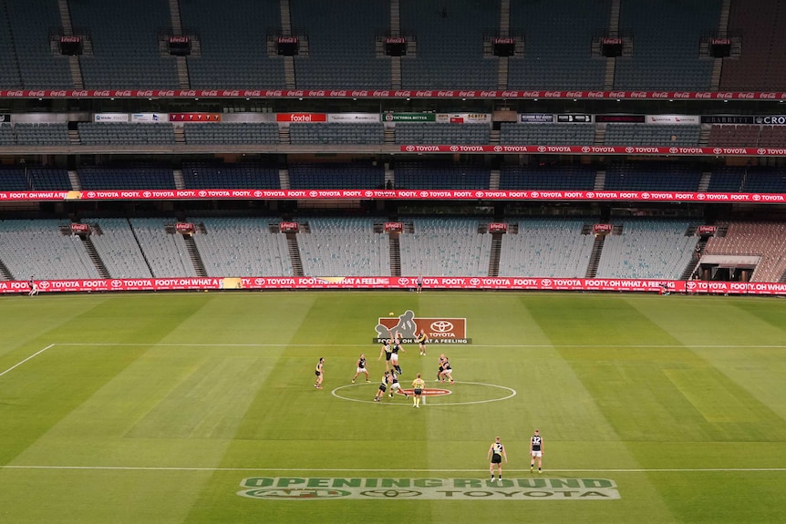 An AFL match is played at the MCG with no spectators in the stadium.