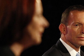 Tony Abbott looks at Gillard during the debate (AAP)