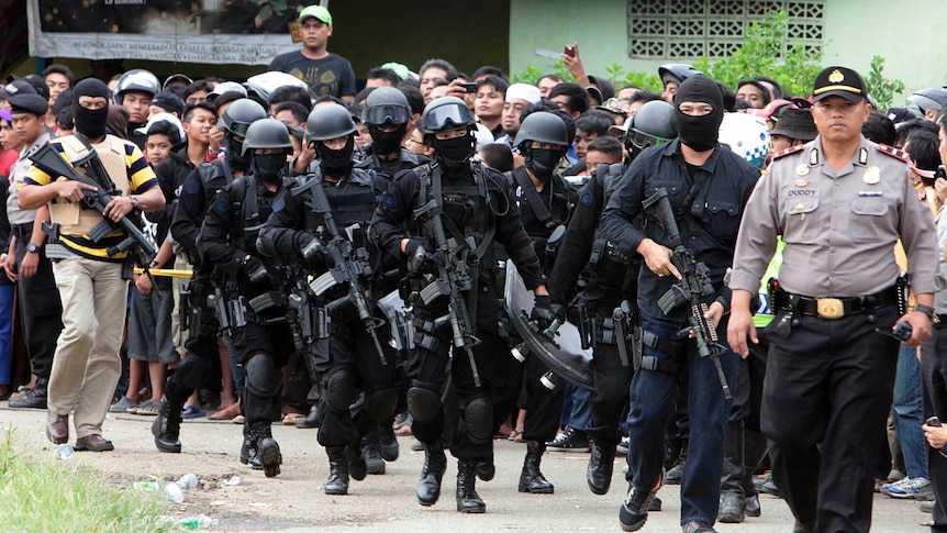 Members of Indonesian anti-terrorism police arrive at the village of Batu Rengat, in Bandung, West Java.