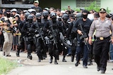 Members of Indonesian anti-terrorism police arrive at the village of Batu Rengat, in Bandung, West Java.