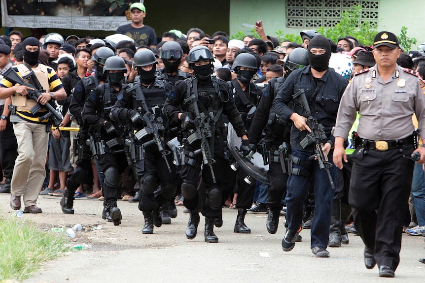 Members of Indonesian anti-terrorism police arrive at the village of Batu Rengat, in Bandung, West Java.