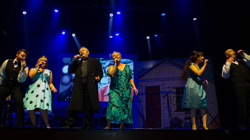 Six singers lineda cross the front of stage, giving it their all.