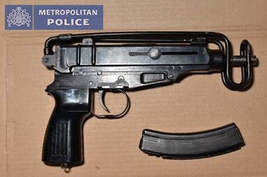A sub machine gun with clip of ammunition.