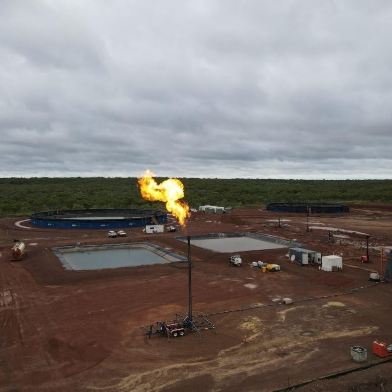 a gas flare in front of an exploration well. 
