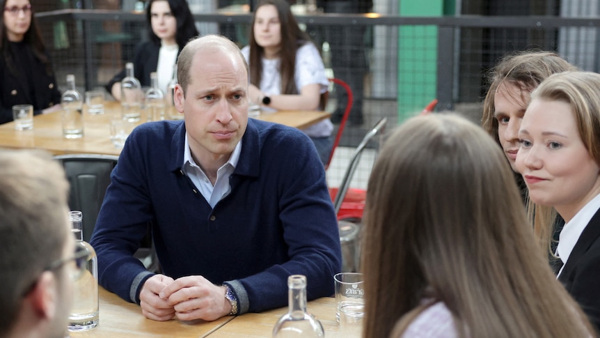Prince William looks at a teenage girl with pity