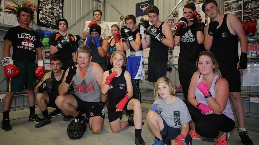 The South East Boxing Club pose for a photo with inside their gym rooms.