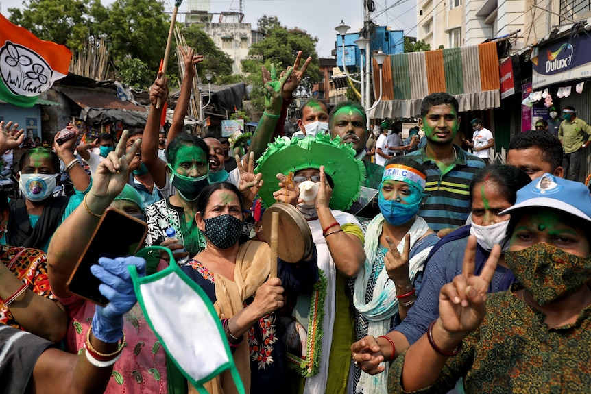 Supporters of Chief Minister of West Bengal state celebrate after the initial poll results.