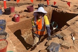Archaeologist unearthing an old cesspit