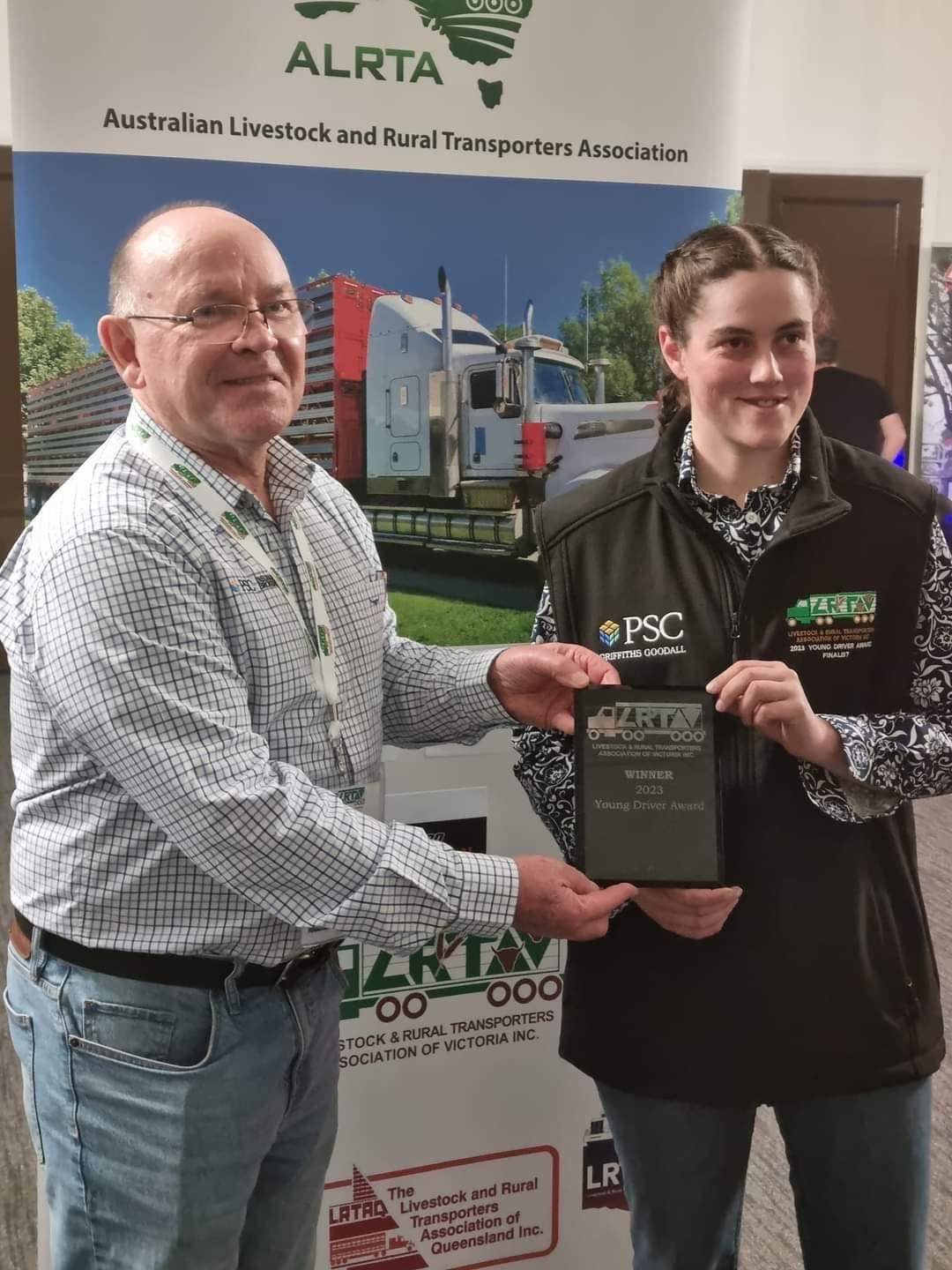 A man hands a women an award 