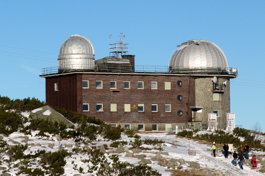 A large building with two silver domes on its roof