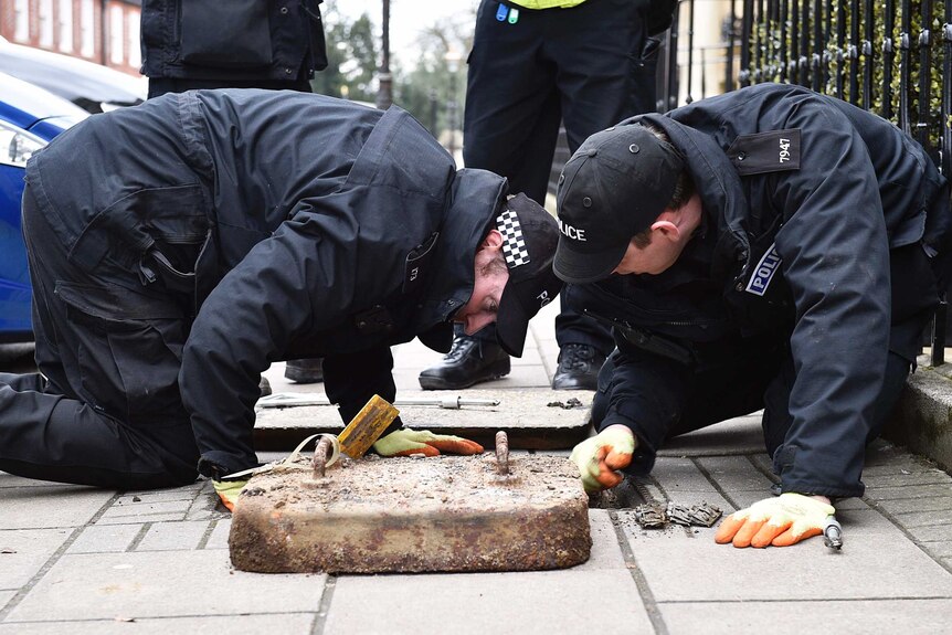 Officers carry out a drain check.