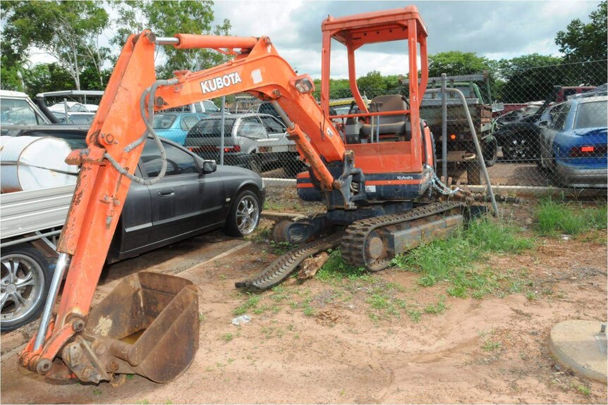 The excavator police allege was used to pre-dig a grave in Darwin's rural area.