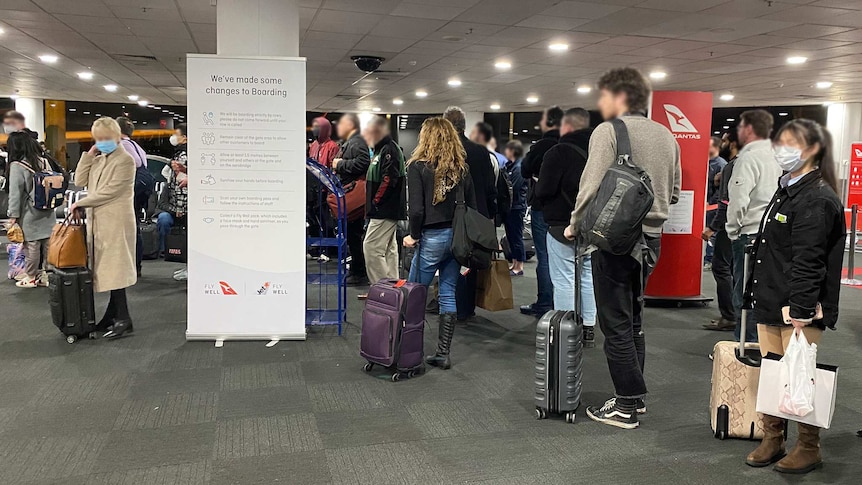 Photo of a crowded boarding lounge area.