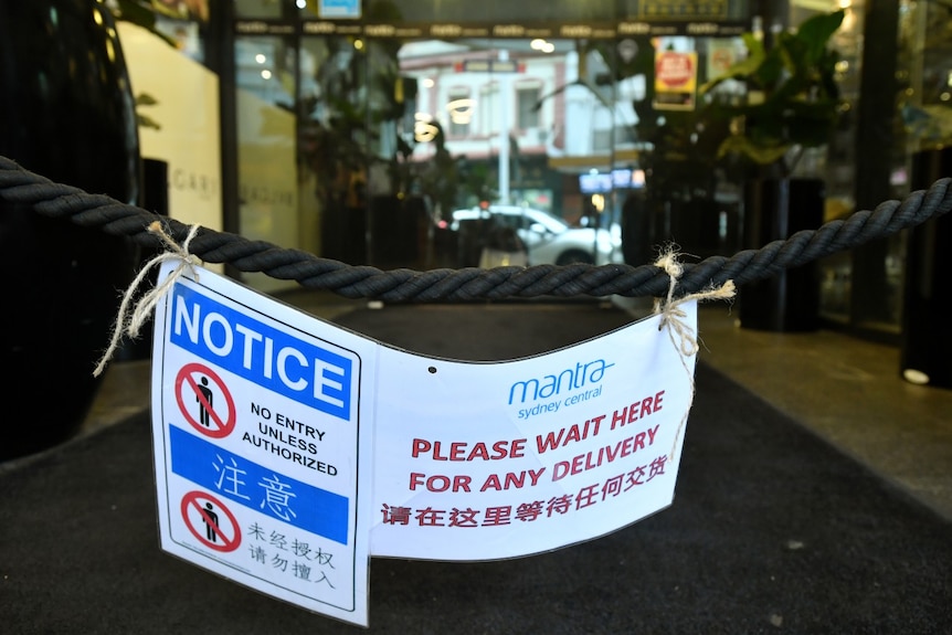 A sign outside the Mantra tells delivery workers to wait and a roped off area.