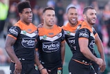 Wests Tigers celebrate a Luke Brooks try against the Dragons.