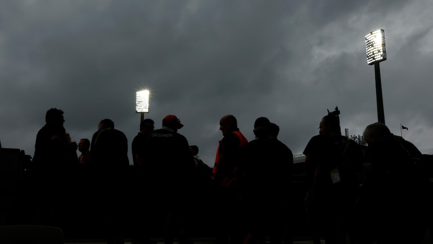 Silhouettes of spectators in the crowd under lights at the SCG during a Test between Australia and Pakistan.