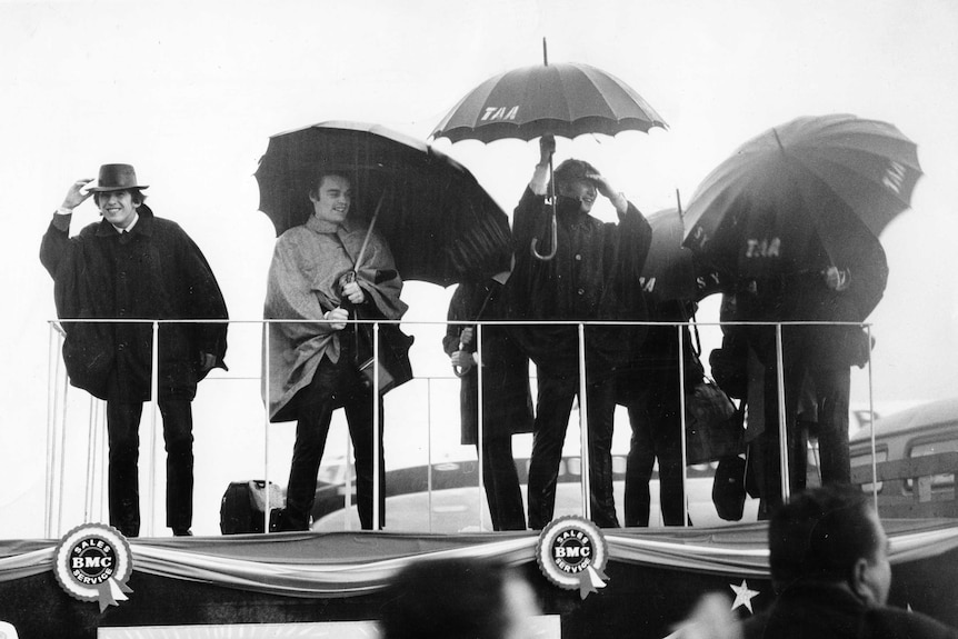 The Beatles brave the rain in Sydney, during their Australian tour in 1964.