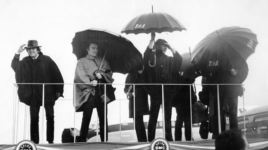 The Beatles brave the rain in Sydney, during their Australian tour in 1964.