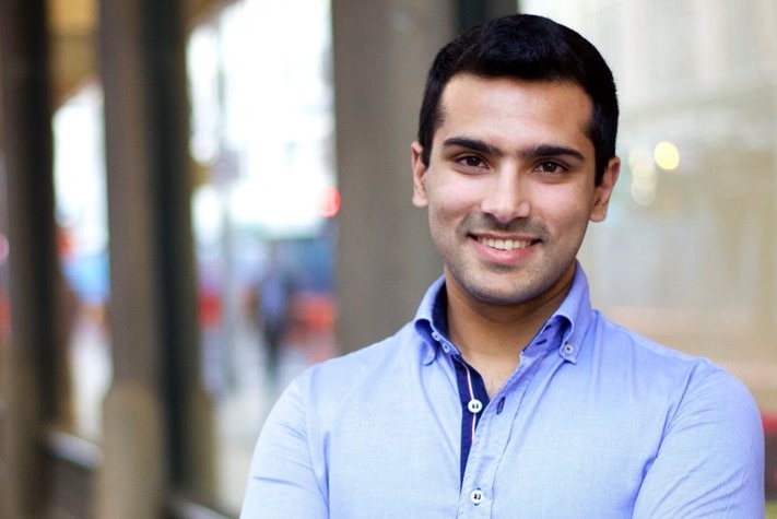 A smiling Mohammad Al-Khafaji outside his office