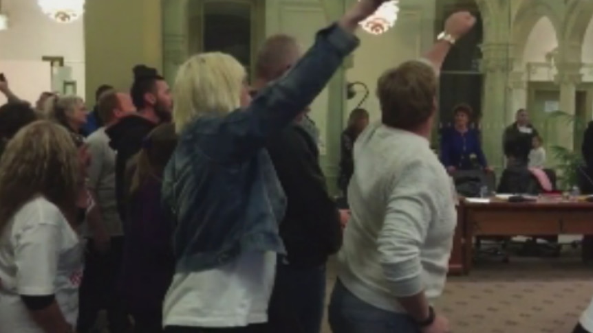 Protesters chant at a Bendigo Council meeting forcing its closure