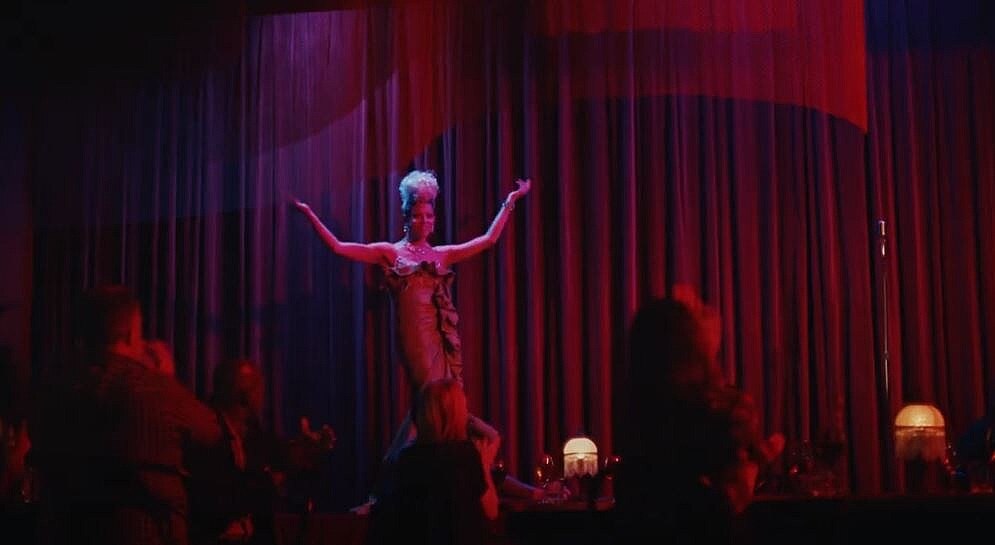 a performance with arms outstretched in front of an audience