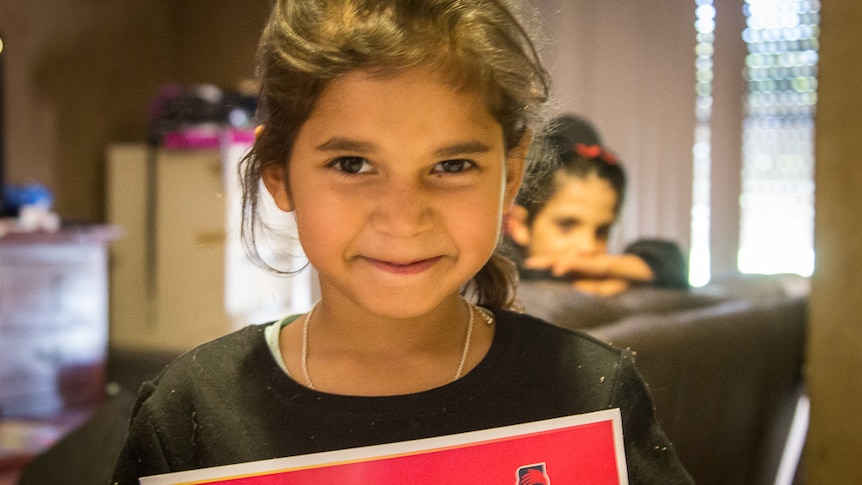 Six year old Janie with her certificate for perfect attendance.