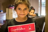 Six year old Janie with her certificate for perfect attendance.