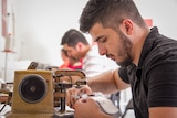Syrian refugee Dilo Maho working on a sewing machine in Toowoomba.