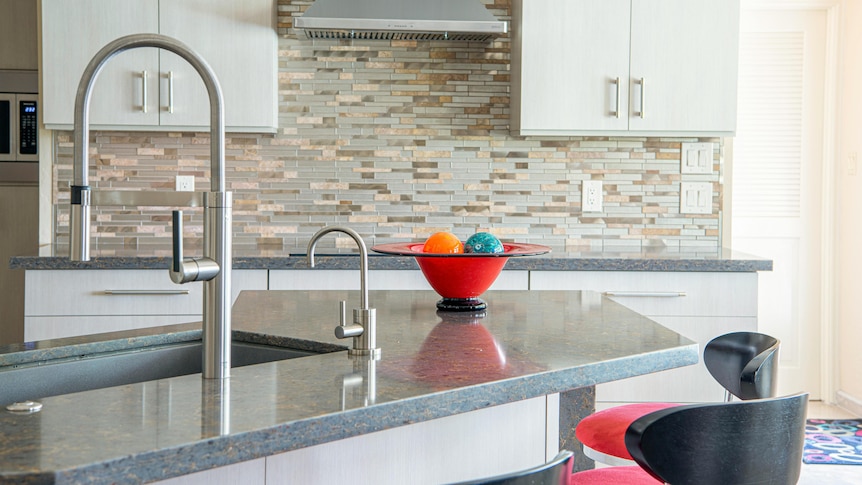 A generic image of an engineered stone kitchen bench in a modern kitchen.