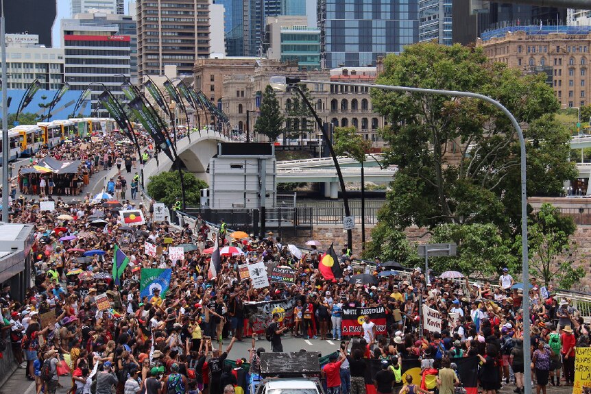 A crowd of hundreds rallies in Brisbane city on the Victoria Bridge.