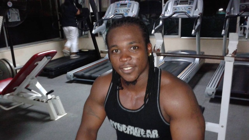 A man with dreadlocks in a gym