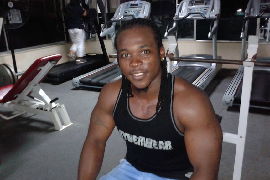 A man with dreadlocks in a gym