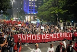 Demonstrators carry banners during a march in the streets of Sao Paulo in Brazil.