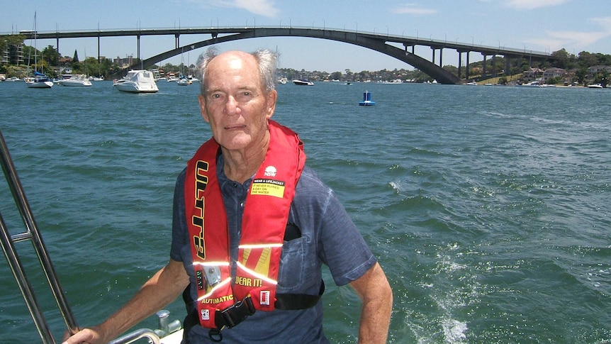 Tony Gee on a boat in front of the Gladesville Bridge.