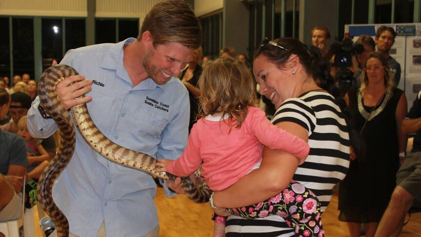 Snake Catcher Richie Gilbert showing snake to a child at an information evening in Agnes Water in October 2016.
