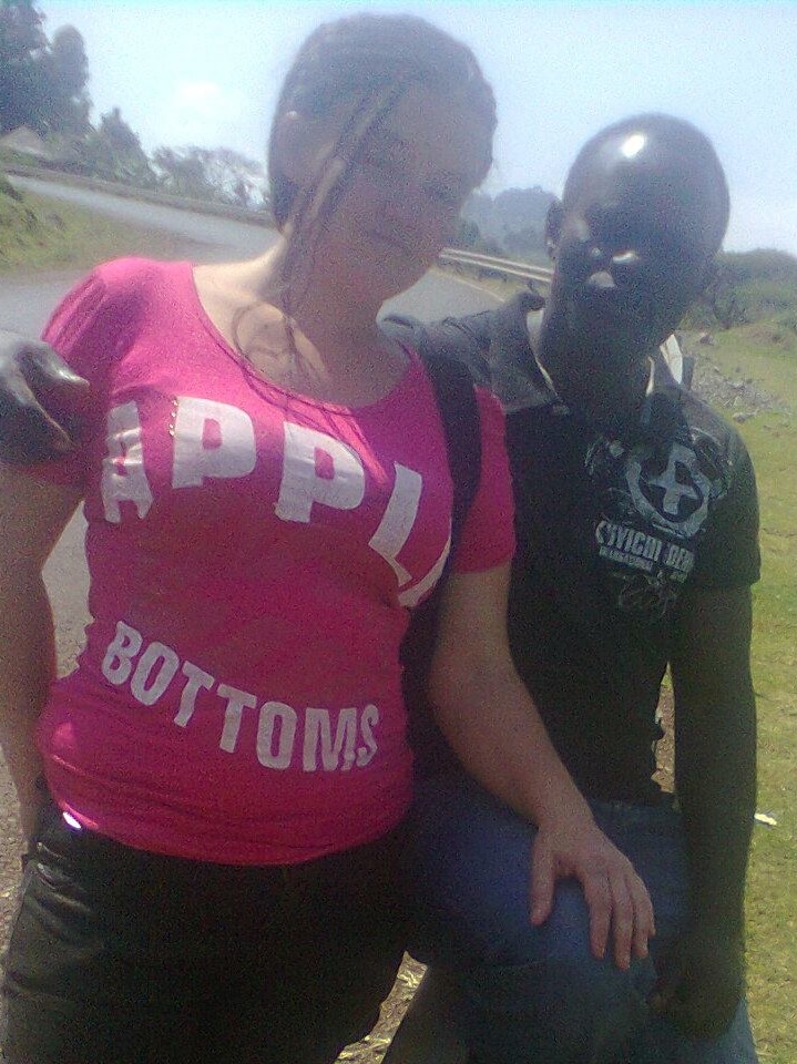 Bronwyn Fielding with husband Michael Osago sitting on a road barrier.