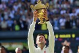 Novak Djokovic holds the winner's trophy after beating Roger Federer in the men's final at Wimbledon.